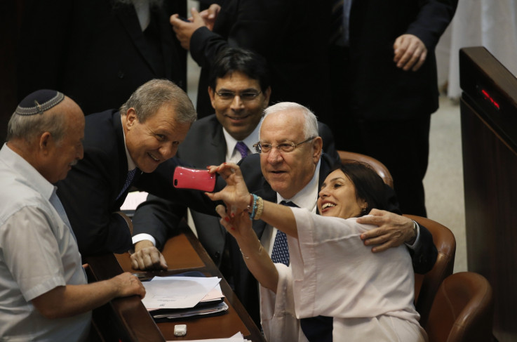Israeli lawmaker Miri Regev (R) takes a selfie with presidential candidates, former Speaker of Parliament Reuven Rivlin (2nd R) and former Finance Minister Meir Sheetrit (2nd L)
