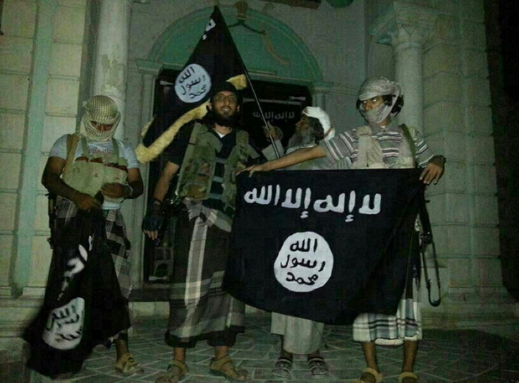 Yemeni al Qaida militants pose with the black flag of jihad, since adopted by Isis (Getty)