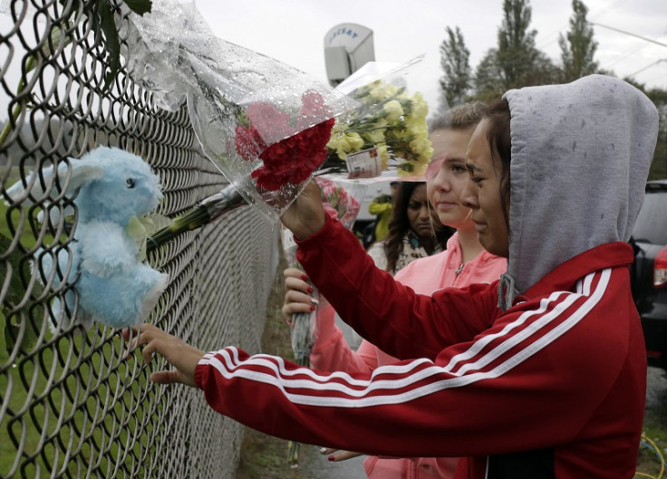 Student Tyanna Davis places flowers outside Marysville-Pilchuck High School the day after Jaylen Fryberg went on a shooting spree in the school cafeteria
