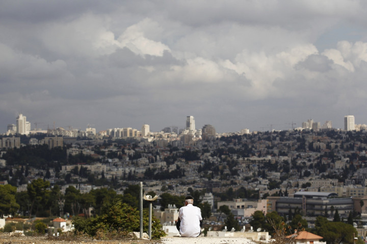 A view of Jerusalem is seen in the background as a man sits in Giv'at HaMato A view of Jerusalem is seen in the background as a man sits in Giv'at HaMato