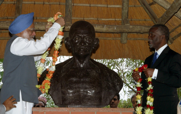 Indian Prime Minister Manmohan Singh (L) and South African President Thambo Mbeki garland a bust of the late Mahatma Gandhi who lived in South African for 21 years