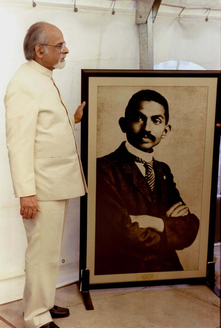 Indian Prime Minister Inder Kumar stands next to a picture of Mahatma Gandhi at the Johannesburg prison