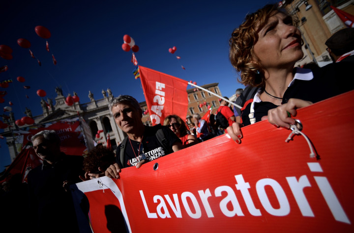 Protestors holding a banner arrive in San Giovanni square during a demonstration organised by Italian General Confederation of Labour (CGIL) union Protestors holding a banner arrive in San Giovanni square during a demonstration organised by Italian General Confederation of Labour (CGIL) union