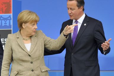 Britain's Prime Minister David Cameron (R) greets German Chancellor Angela Merkel