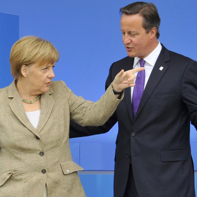 Britain's Prime Minister David Cameron (R) greets German Chancellor Angela Merkel