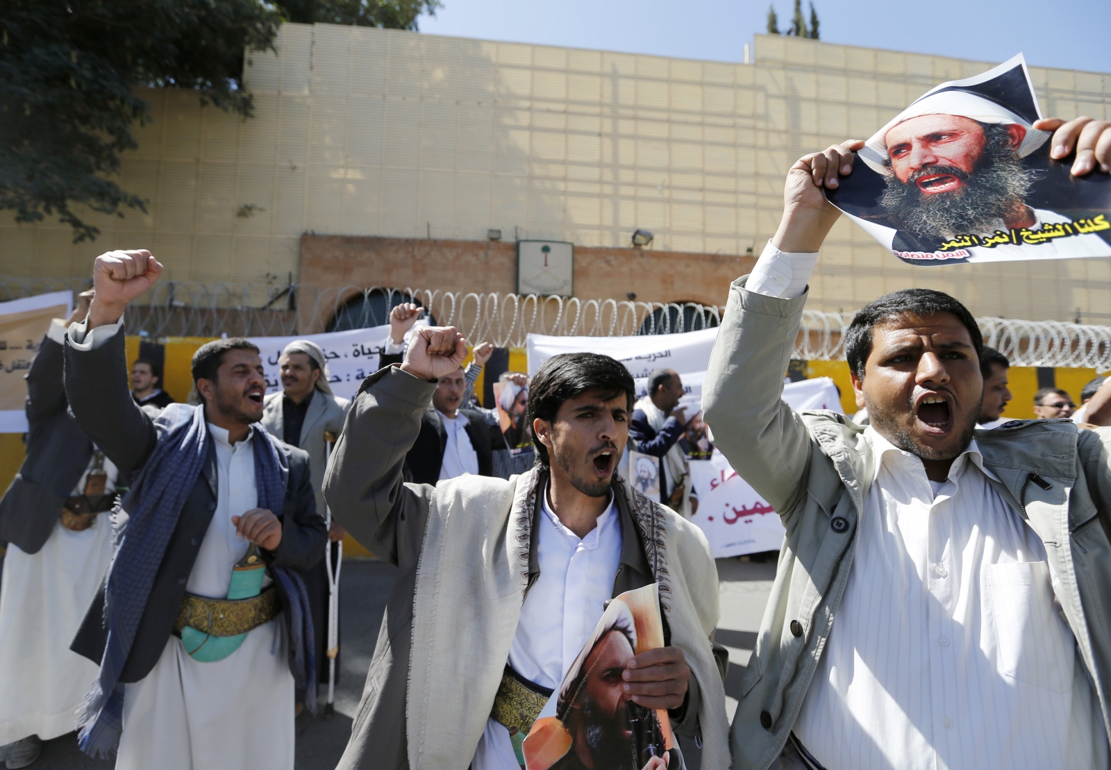 Shi'ite protesters carry posters of Sheikh Nimr al-Nimr during a demonstration outside the Saudi embassy in Sanaa Shi'ite protesters carry posters of Sheikh Nimr al-Nimr during a demonstration outside the Saudi embassy in Sanaa