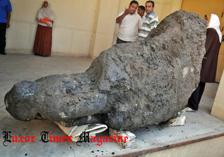 The pink granite statue of a seated figure will now be taken to a site in Saqqara to be restored