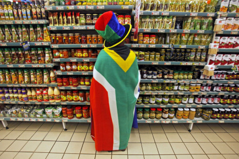 woman with a South African flag draped around her shops for groceries in Pretoria