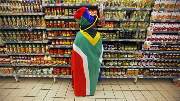 woman with a South African flag draped around her shops for groceries in Pretoria