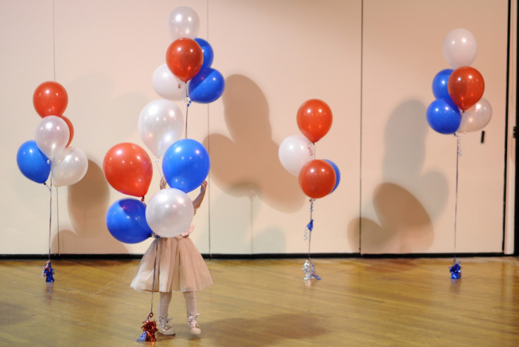 A little girl plays with balloons at Republican U.S. Senate candidate Scott Brown's midterm election night rally in Manchester, New Hampshire November 4, 2014