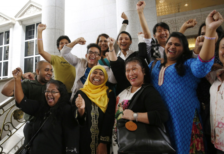 Activists celebrate overturning a sharia law against cross-dressing at the Appeals Court in the Palace of Justice in Putrajaya November 7, 2014