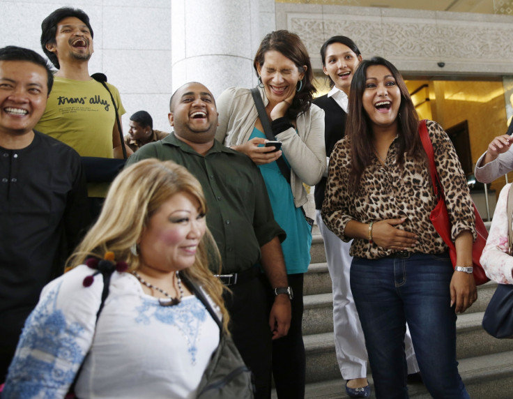 Activists celebrate overturning a sharia law against cross-dressing at the Appeals Court in the Palace of Justice in Putrajaya November 7, 2014