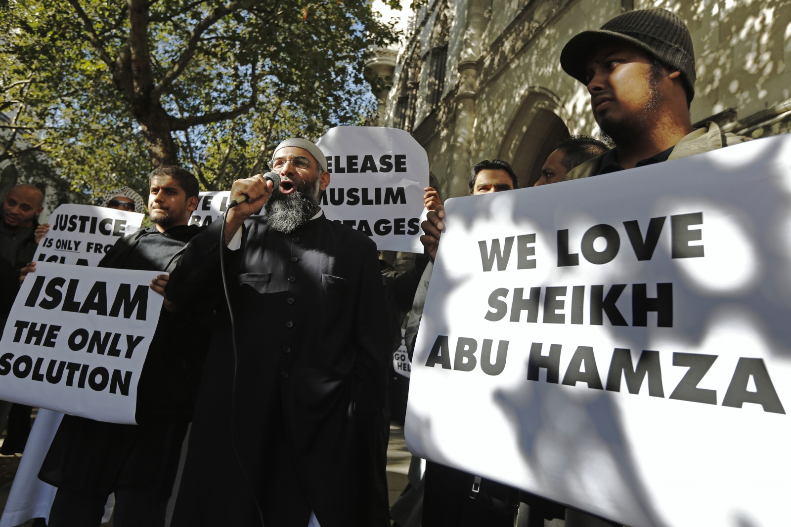 Protester Anjem Choudary (C), speaks into a microphone during a demonstration in support of Islamist cleric Abu Hamza al-Masri, who is appealing against his extradition to the U.S Protester Anjem Choudary (C), speaks into a microphone during a demonstration in support of Islamist cleric Abu Hamza al-Masri, who is appealing against his extradition to the U.S