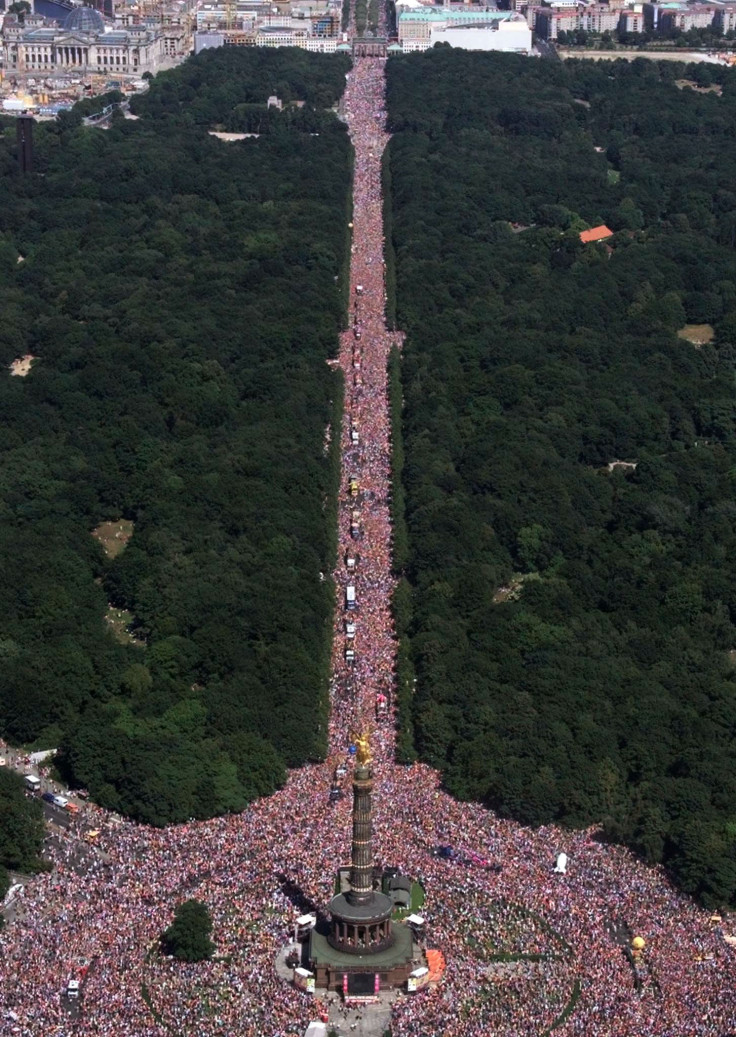 Berlin's Tiergarten area with the famous landmark Siegessauele (victory column) in foreground and the Brandenburg Gate at rear during the annual Love parade techno music fest circa 1999