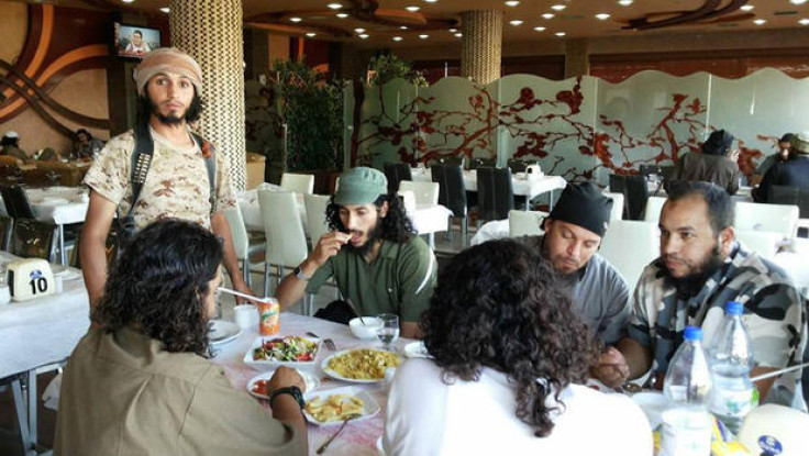 An image from the Syrian Observatory for Human rights, which shows Isis militants enjoying a meal in Raqqa, Syria.