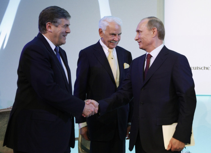 Russian President Vladimir Putin (R) shakes hands with ex-Deutsche Bank Chief Executive Officer Josef Ackermann (L) as the head of Knauf Group Nikolaus Wilhelm Knauf in 2010