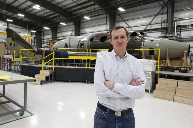 Virgin Galactic's CEO George T. Whitesides stands in front of their new spaceship N202VG, which the company began building 2 and a half years ago, in a hangar at Mojave Air and Space Port in Mojave, California November 4, 2014.