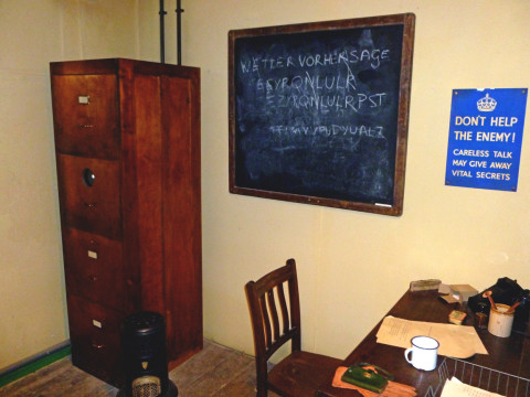 An office in one of the huts, showing a black board where a message is being decrypted