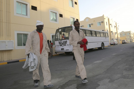 Labourers, who are working on the Qatar 2022 World Cup project, arrive at their accommodation in Doha