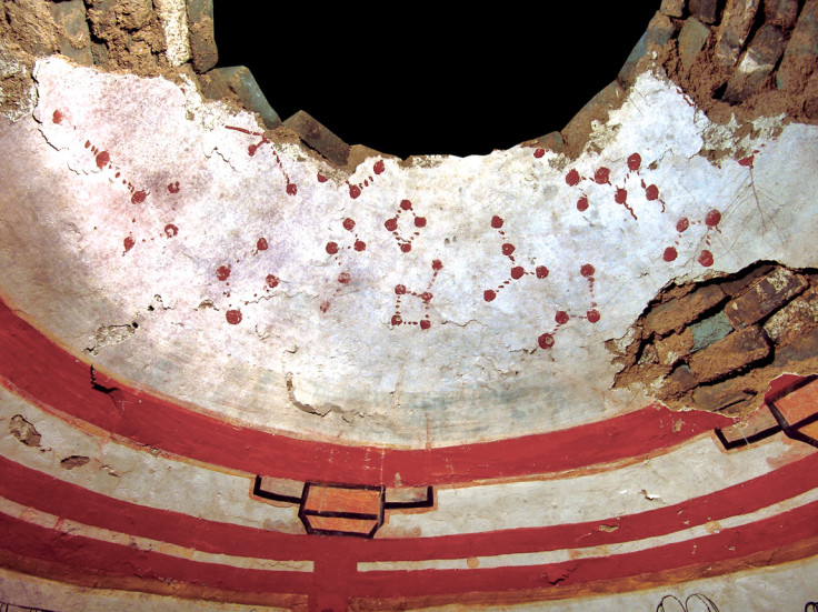 The curved ceiling of the circular tomb, which features constellations of stars painted in red