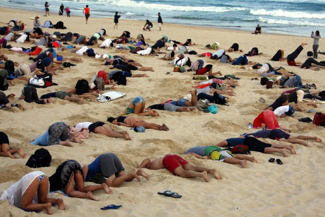 protesters bury heads in sand