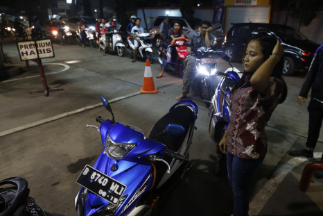 Motorcyclist line up for fuel at a state-owned Pertamina petrol station in Tangerang