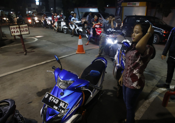 Motorcyclist line up for fuel at a state-owned Pertamina petrol station in Tangerang