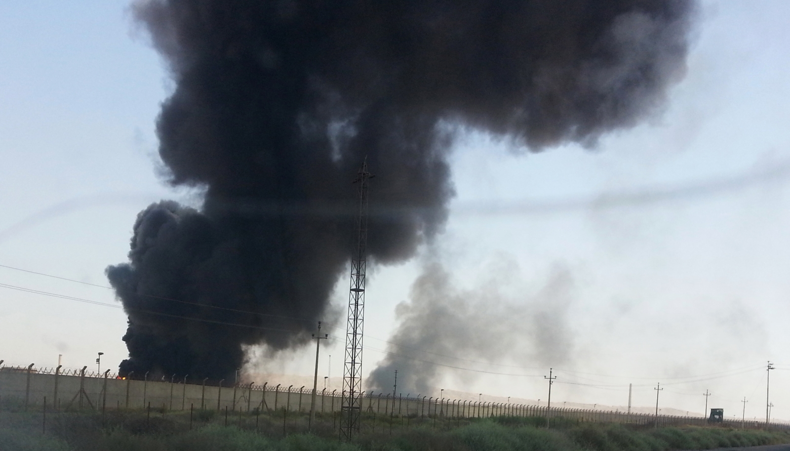 Smoke rises from the Baiji oil refinery following combat between Isis militants and Iraqi forces in June. (Reuters)