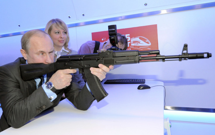 Russian president Vladimir Putin fires a Kalashnikov assault rifle. (Getty)