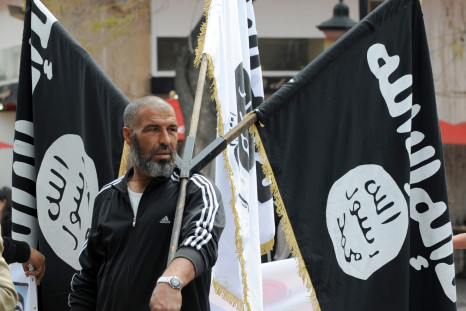 An Islamist holds aloft the Isis flag at a demonstration in Tunis. (Getty)