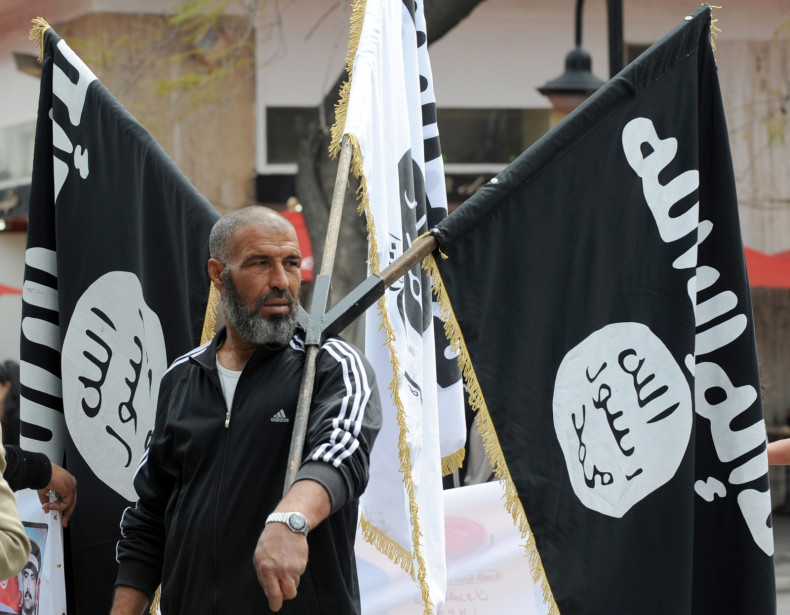 An Islamist holds aloft the Isis flag at a demonstration in Tunis. (Getty)