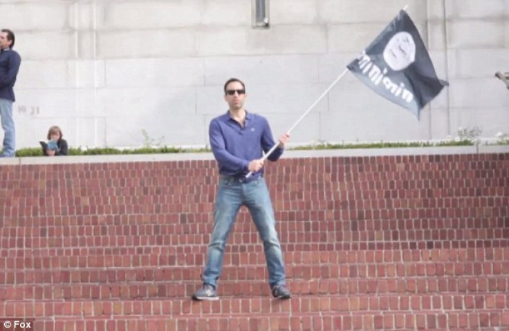 Filmaker Ari Horowitz waves the Isis flag on Berkeley campus. (YouTube)