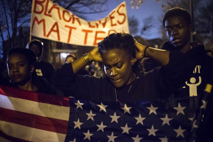 Protesters await the decision of a grand jury whether to indict police officer Darren Wilson