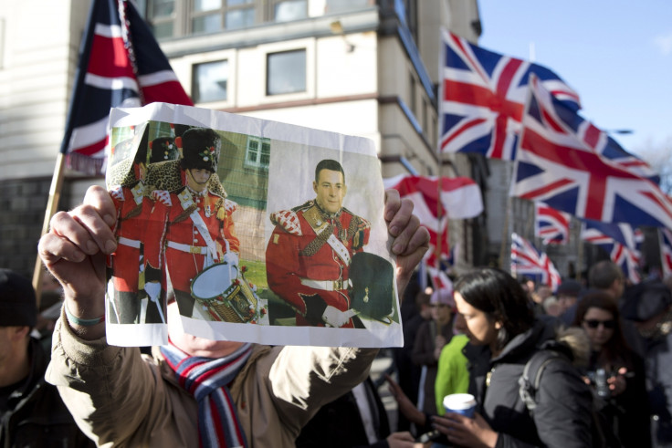 A demonstrator holds a picture of murdered soldier Lee Rigby during a protest
