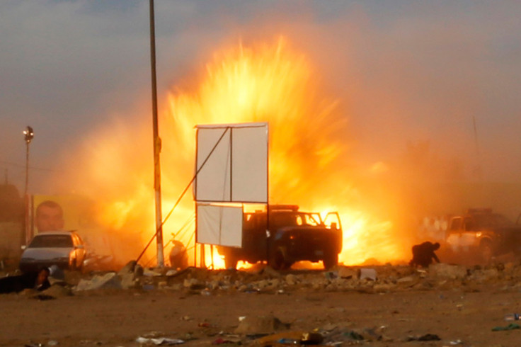 April 25, 2014: An explosion is seen during a car bomb attack at a rally by militant group, Asaib Ahl Haq (League of the Righteous), to introduce its candidates for elections at a football stadium in Baghdad
