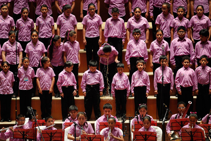 May 13, 2014: A young member of the choir of "Sinfonia por el Peru" vomits before performing with Peruvian tenor Juan Diego Florez at Lima's National Theatre