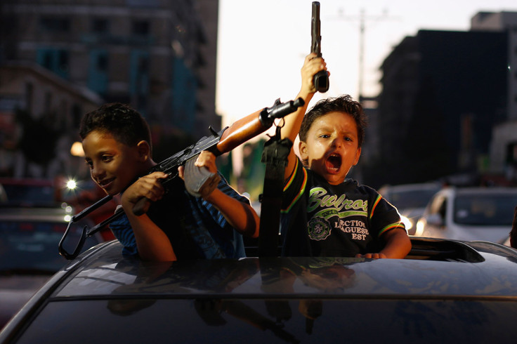 August 26, 2014: Palestinian children hold guns as they celebrate "a victory" over Israel, following a ceasefire in Gaza City