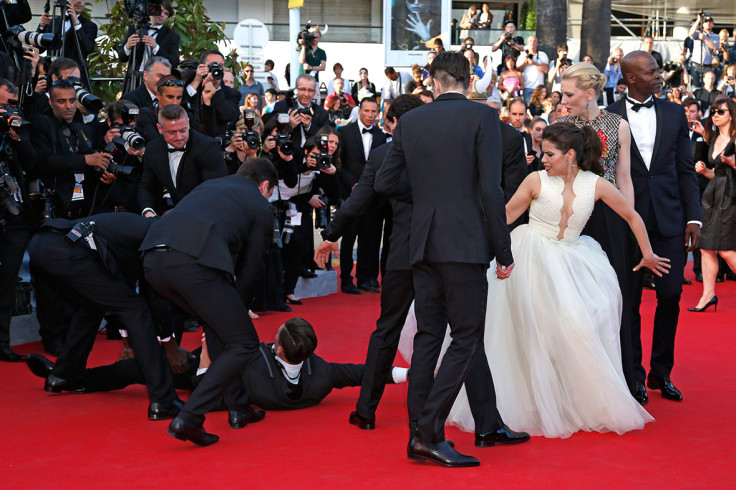 May 16, 2014: A man is arrested by security as he tries to slip under the dress of actress America Ferrera in Cannes