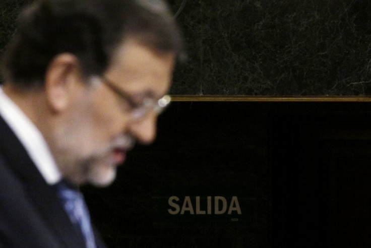 Spain's Prime Minister Mariano Rajoy delivers a speech presenting anti-corruption measures in front of an exit sign at Spanish parliament in Madrid, November 27, 2014.