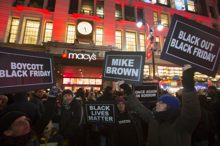 Protesters hold signs aloft outside Macy's before the kick off of Black Friday sales in New York November 27, 2014. Select stores opened Thursday to kick off the Black Friday sales, with the Friday after Thanksgiving typically being the busiest shopping