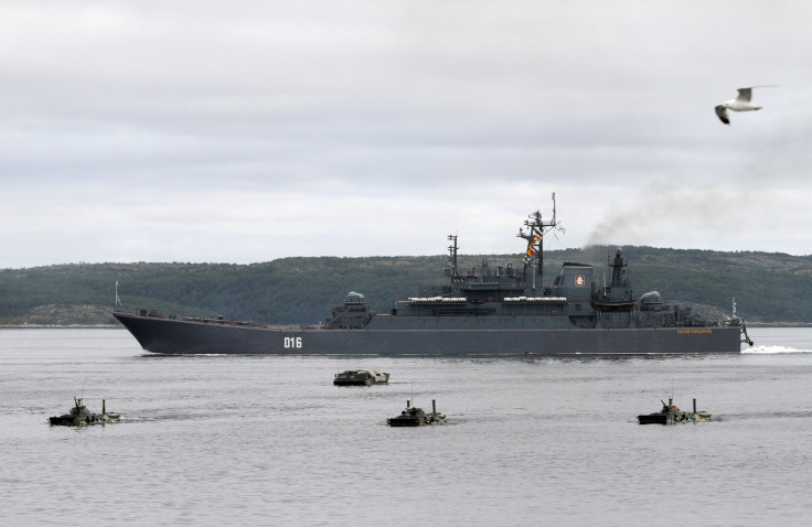 A Russian warship and amphibious military vehicles move during a naval parade rehearsal at the port of Severomorsk in the Barents sea July 29, 2011