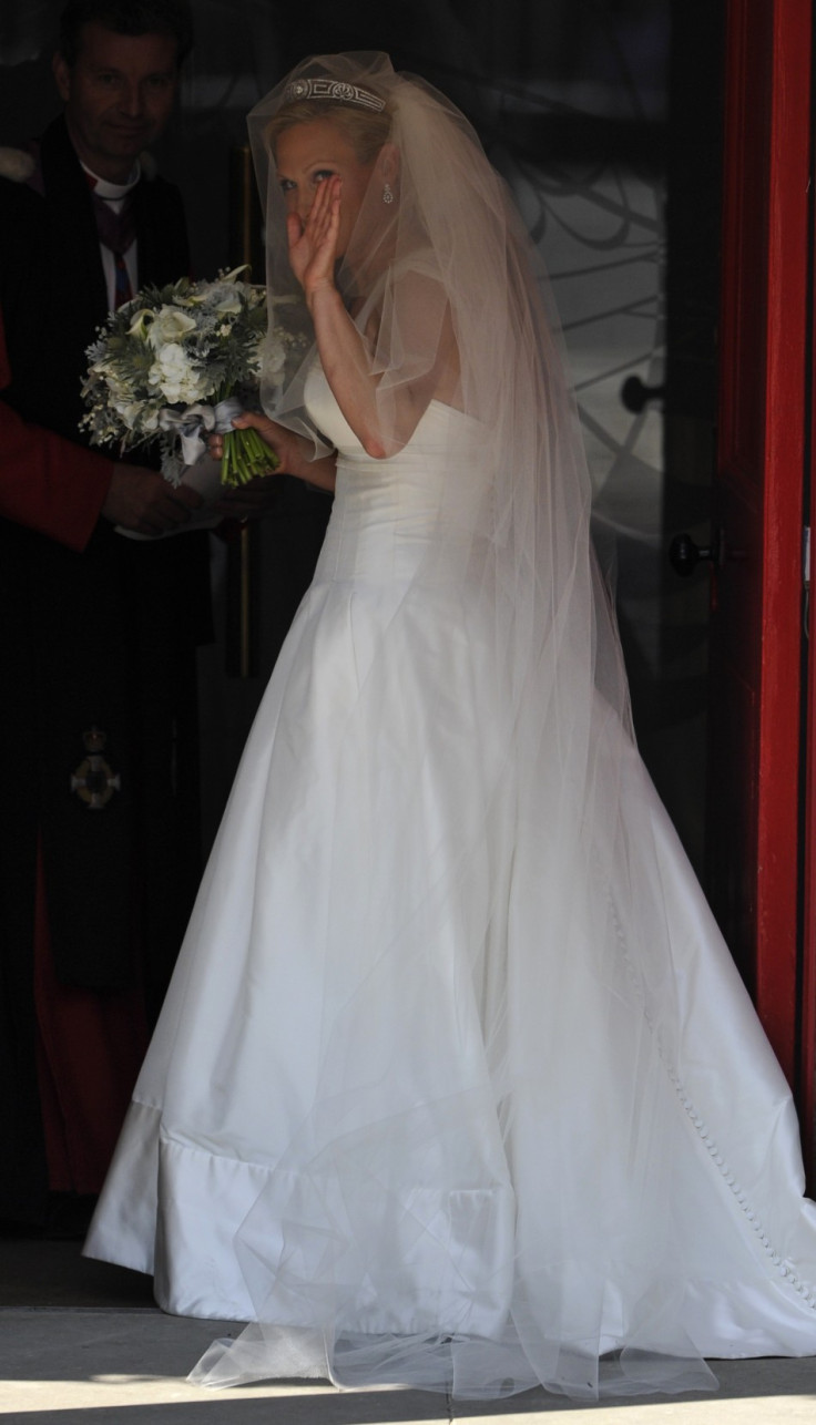 Britain's Zara Phillips waves as she arrives for her marriage to Mike Tindall at Canongate Kirk in Edinburgh