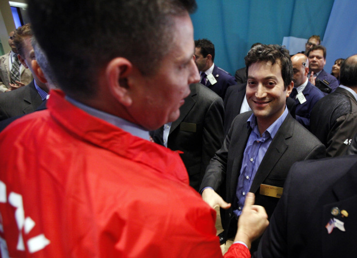 Shutterstock founder and CEO Jon Oringer (R) celebrates his company's first trades following it's IPO on the floor of the New York Stock Exchange, October 11, 2012.