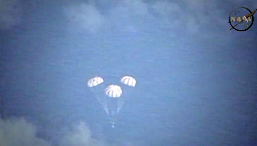 Images from Nasas Ikhana unmanned aerial drone show the Orion crew module landing in the Pacific Ocean