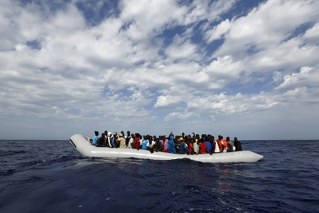 rubber dinghy with 104 sub-Saharan Africans on board waiting to be rescued by the NGO Migrant Offshore Aid Station rubber dinghy with 104 sub-Saharan Africans on board waiting to be rescued by the NGO Migrant Offshore Aid Station