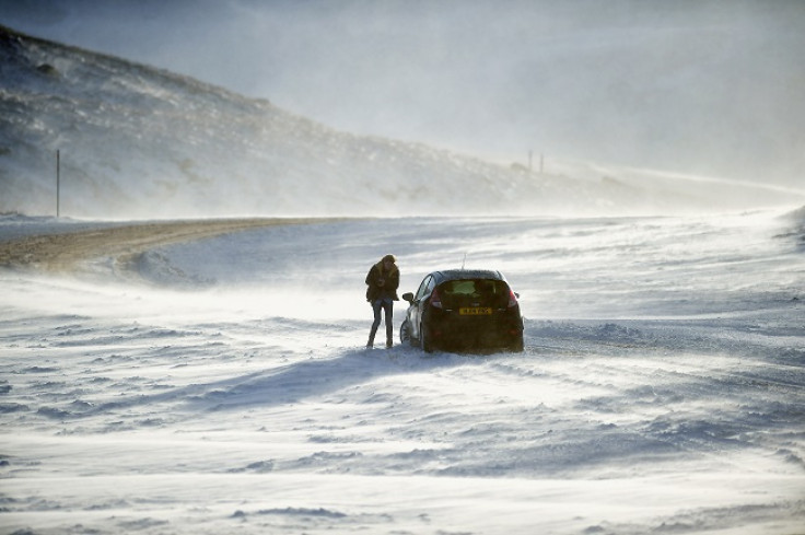 People push a car stuck on the A93 Braemar to Glenshee road, Scotland