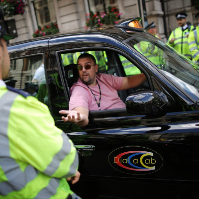 Black taxi driver during protest against cab app Uber in London