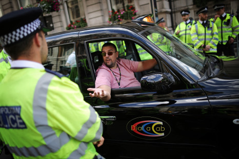 Black taxi driver during protest against cab app Uber in London