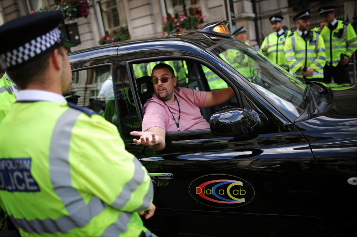 Black taxi driver during protest against cab app Uber in London