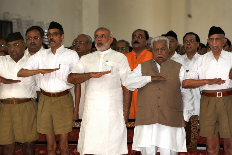 Gujarat state Chief Minister Narendra Modi (3rd L) and former chief minister Keshubhai Patel (2nd R, front) gesture as they attend a Rashtriya Swayamsevak Sangh (RSS) gathering at the Tria Mandir in Adalaj, some 20 kms from Ahmedabad